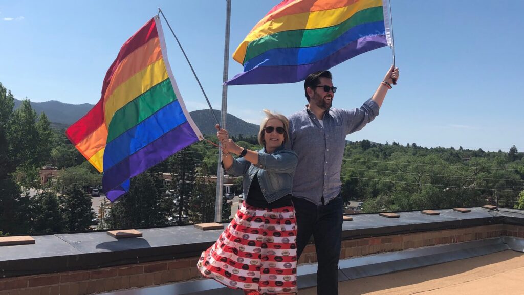Gov. Lujan Grisham and Speaker Egolf hoist Pride flags atop the Capitol in Santa Fe